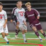 Mercer Island Islanders midfielder Matt Capone (right), passes the ball to a teammate in a contest against the Juanita Rebels during the 2019 season. Capone will play soccer at Northwest Nazarene University this fall. Photo courtesy of Patrick Krohn/Patrick Krohn Photography