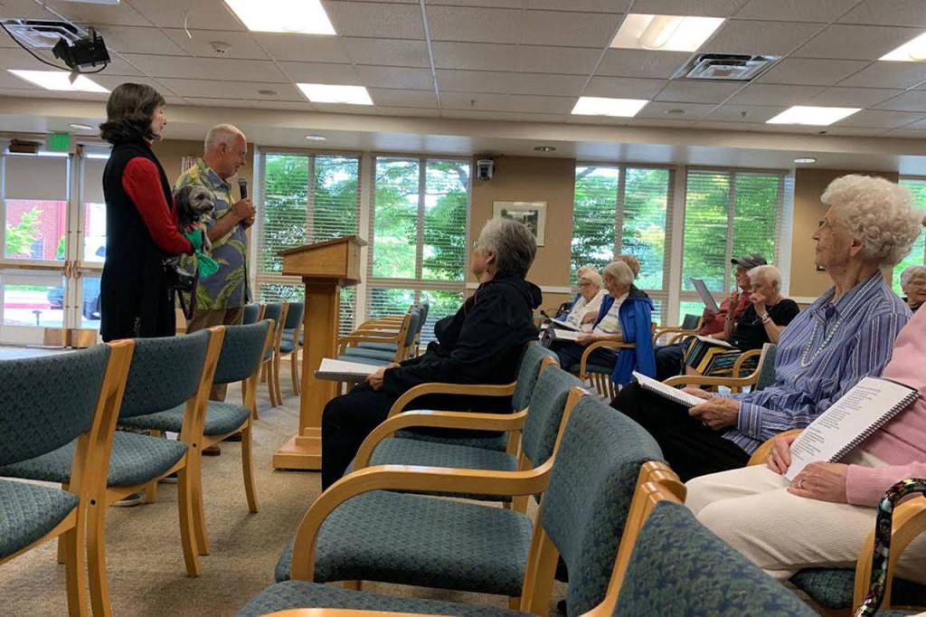 Mercer Island seniors sing from their songbooks in the Fellowship Hall at Covenant Living at the Shores on July 17. Madeline Coats/staff photo                                 Pastor Greg Asimakoupoulos and Rotarian Karen Dunning guided the group through 15 songs during the sing-a-long program. Madeline Coats/staff photo