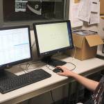 Mason Meinzinger, an incoming MIHS sophomore, works to organize the 500-plus song playlist for Log Boom Radio. Madison Miller / staff photo