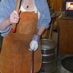 Author Claire Gebben gives blacksmithing a go at Bruce Weaklys private shop on Whidbey Island. Gebben sought to learn the art of blacksmithing to better understand the life of her great-great grandfather, who immigrated to Cleveland in the mid-1800s. Photo courtesy of Claire Gebben