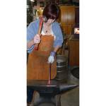 Author Claire Gebben gives blacksmithing a go at Bruce Weaklys private shop on Whidbey Island. Gebben sought to learn the art of blacksmithing to better understand the life of her great-great grandfather, who immigrated to Cleveland in the mid-1800s. Photo courtesy of Claire Gebben