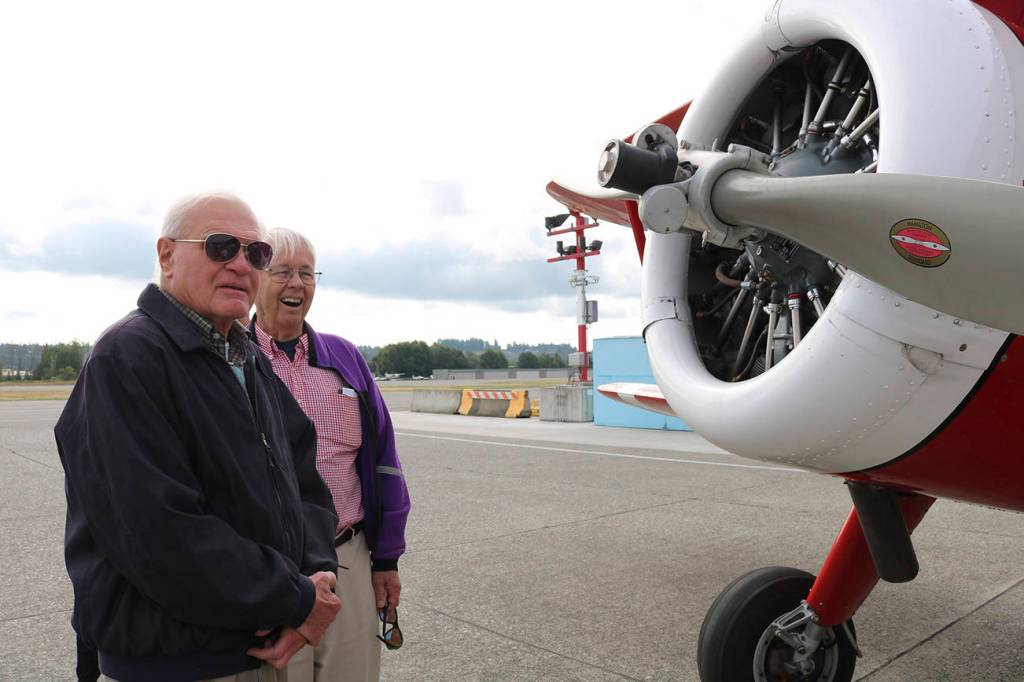 Jack Nelson (left) and Doug Wilkinson take a look at the 1942 Boeing Stearman biplane on Aug. 12.
