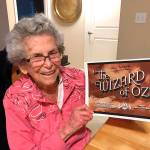 Mercer Island resident Meredythe Glass poses with memorabilia from The Wizard of Oz. Glass was an extra in the film, and was be the guest of honor at a party at her retirement community celebrating Hollywood on Feb. 22. Photo courtesy of Greg Asimakoupoulos