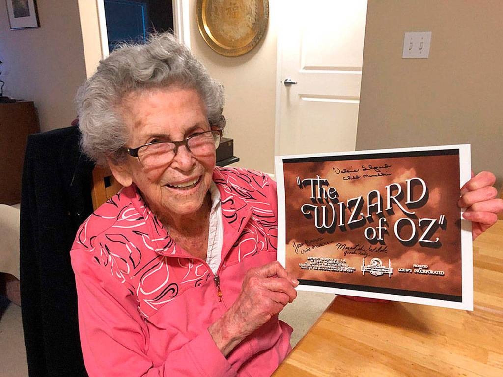 Mercer Island resident Meredythe Glass poses with memorabilia from The Wizard of Oz. Glass was an extra in the film, and was be the guest of honor at a party at her retirement community celebrating Hollywood on Feb. 22. Photo courtesy of Greg Asimakoupoulos