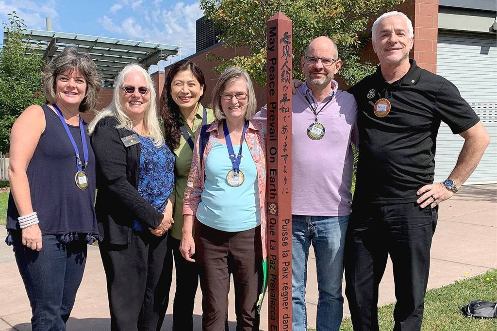 Mercer Island rotarians Beth Baska, Becca Palm, Soonok Kwak, Carol Friends, Steve DeVos and Brent Jordan standing with one of the islands 20 peace poles. Picture by Tracy Drinkwater