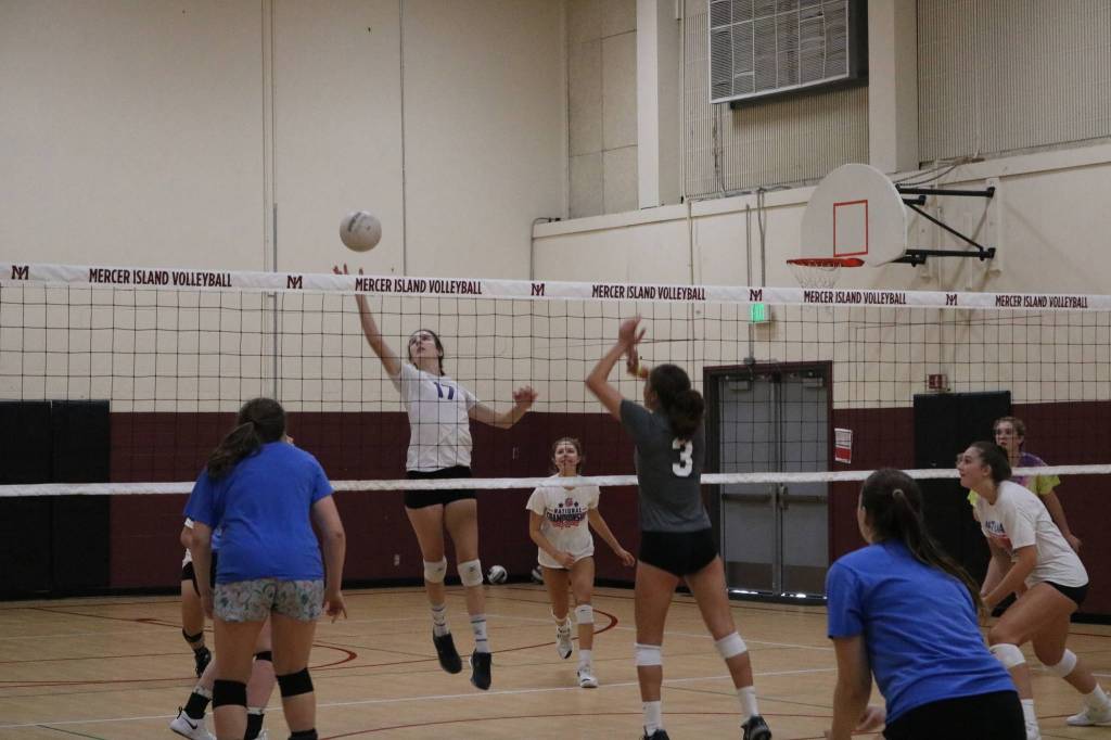 Freshman Leila Obeidat (No. 17) hits the ball while other freshman Samantha Silke (No. 3) looks for a block. Benjamin Olson/ staff photo