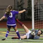 Mercer Island goalkeeper Amy Braman collects the ball from the feet of Issaquahs Jaden Humbyrd (#9) on Sept. 19. Benjamin Olson/ staff photo