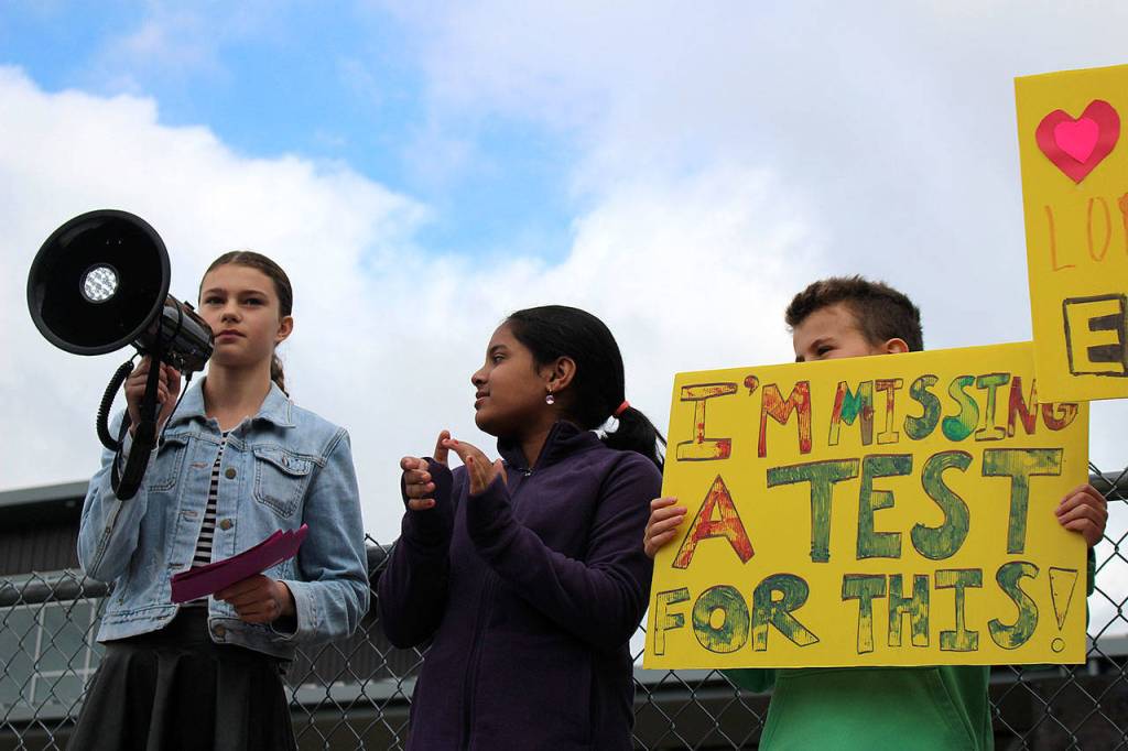 Photo by Madison Miller / staff photo                                Islander Middle School students Rebecca de Broglio and Rhett Hounsell, among others, speak before IMS students at Fridays climate strike.