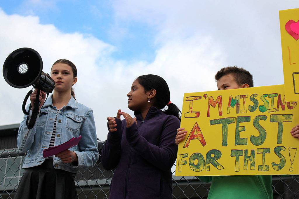 Photo by Madison Miller / staff photo                                Islander Middle School students Rebecca de Broglio and Rhett Hounsell, among others, speak before IMS students at Fridays climate strike.