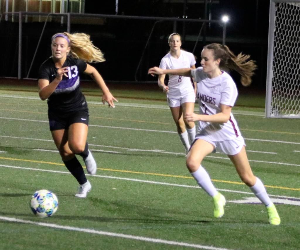 Mercer Island defender Avery Conder and Lake Washingtons Anna Schwisow both go for the ball in a 6-0 Lake Washington win on Oct. 26. Benjamin Olson/ staff photo