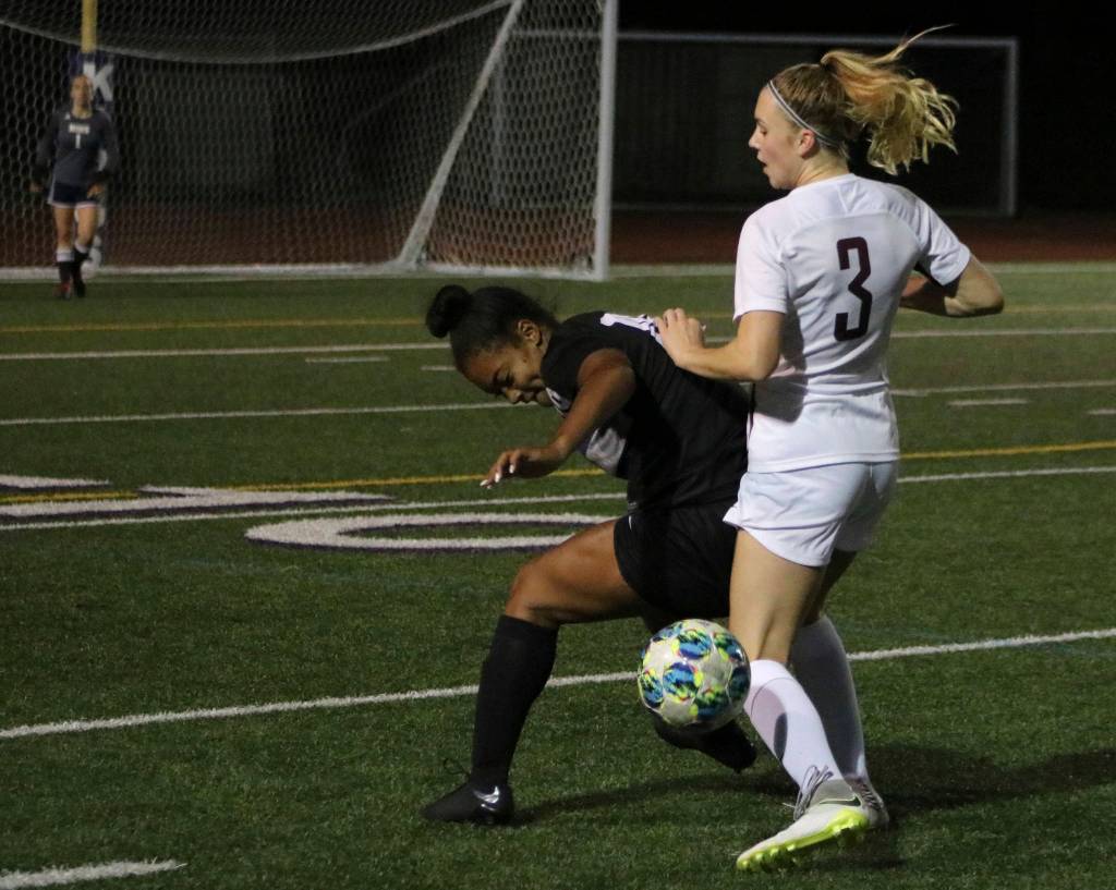 Mercer Island winger Jalyn Sandwith fights for the ball against Lake Washingtons Ari Issa in a 6-0 Islanders loss. Benjamin Olson/ staff photo
