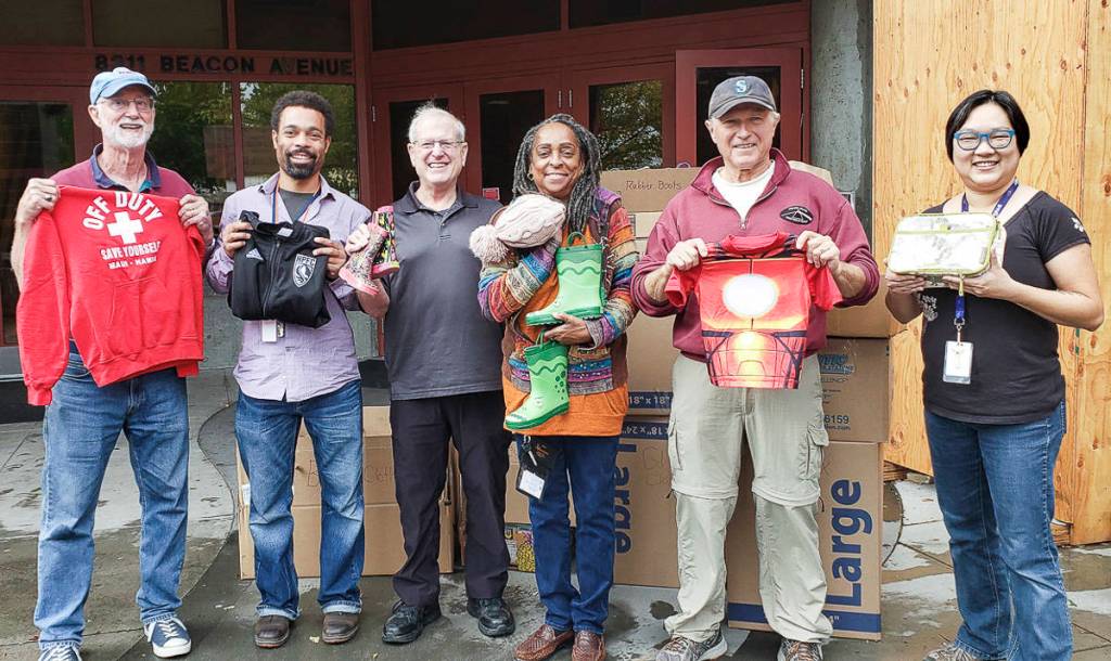 John Hamer, first grade teacher Jonah Randolph, Steve Sheppard, Nina Bowman, John Faith and Kam Yee hold up clothing donation items at Rising Star Elementary School. Courtesy photo