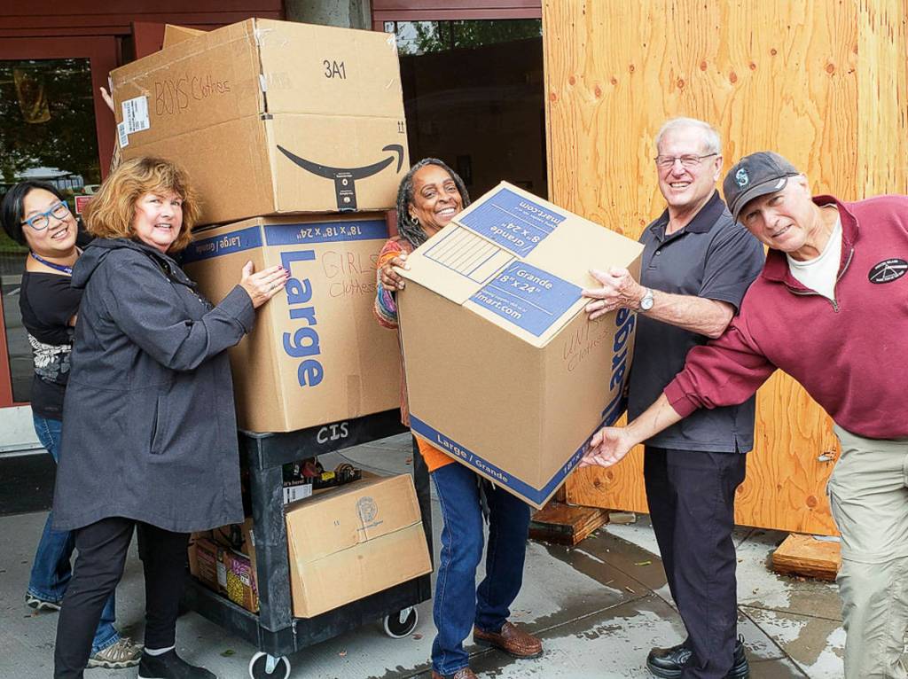Courtesy photo                                From left, Kam Yee, Karolyn Streck, Nina Bowman, Steve Sheppard and John Faith load donated clothes boxes on a cart at Rising Star Elementary School.