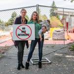 Natalie DeFord/staff photo                                From left, Ashley Hay and Olivia Lippens with baby Monroe in protesting the bus intercept plan in front of the future Mercer Island light rail station.