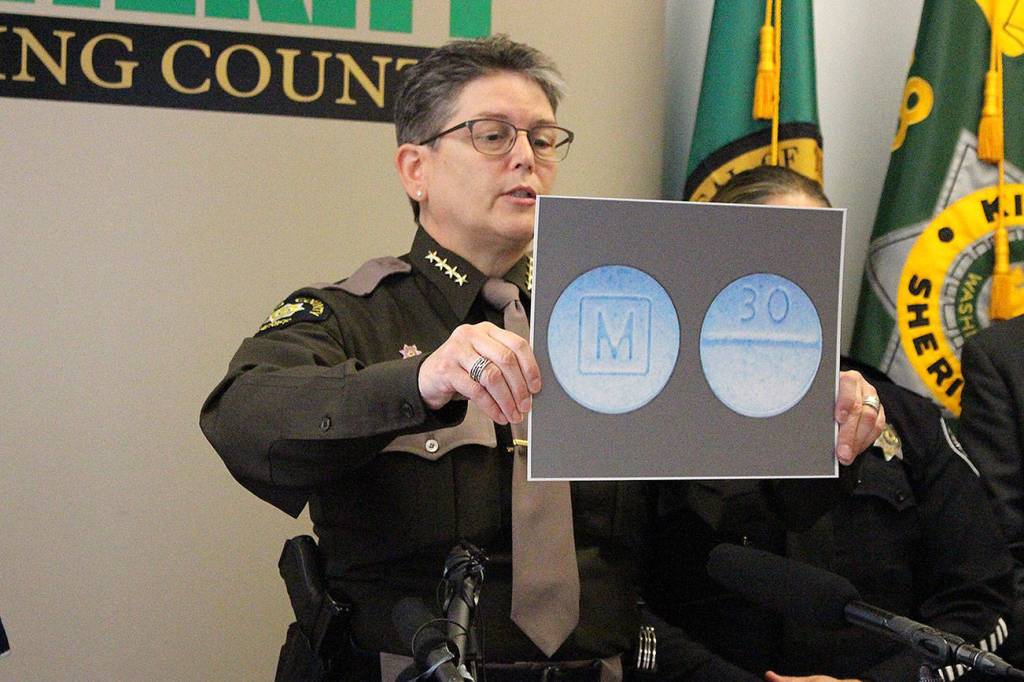 Madison Miller / staff photo                                King County Sheriff Mitzi G. Johanknecht shows what M30 pills look like at a news conference Wednesday.