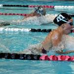 Mercer Island senior Grace Olsen (black cap) finished first in the 200-yard individual medley with a time of 2:11.56 in a meet against Bellevue on Oct. 10. Photo courtesy of Allison Nelson