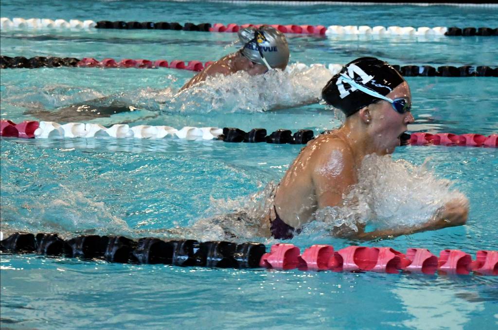 Mercer Island senior Grace Olsen (black cap) finished first in the 200-yard individual medley with a time of 2:11.56 in a meet against Bellevue on Oct. 10. Photo courtesy of Allison Nelson
