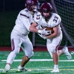 Mercer Island quarterback Clay Dippold (5) hands the ball to running back Jack Rowe (33) during the Islanders 53-14 loss to Bellevue on Nov. 1. Photo courtesy of Stephanie Ault Justus