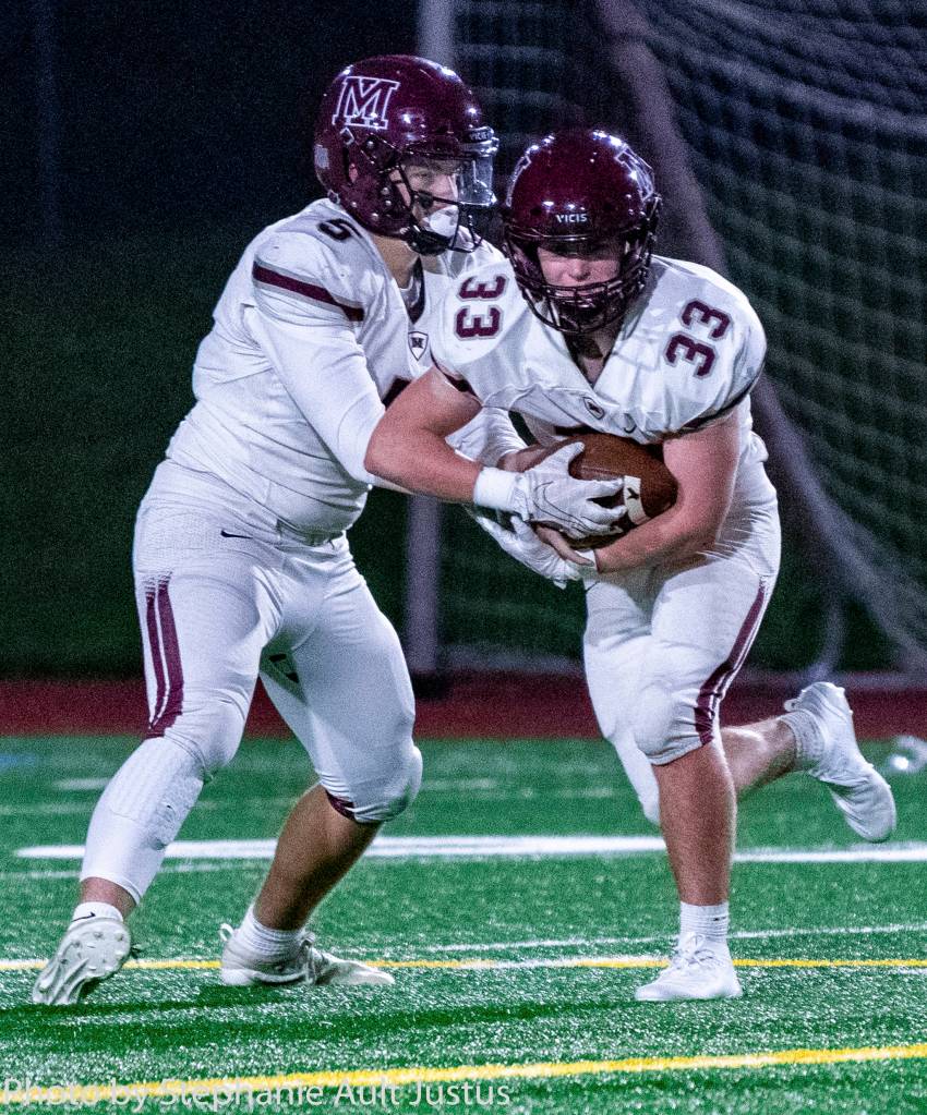 Mercer Island quarterback Clay Dippold (5) hands the ball to running back Jack Rowe (33) during the Islanders 53-14 loss to Bellevue on Nov. 1. Photo courtesy of Stephanie Ault Justus