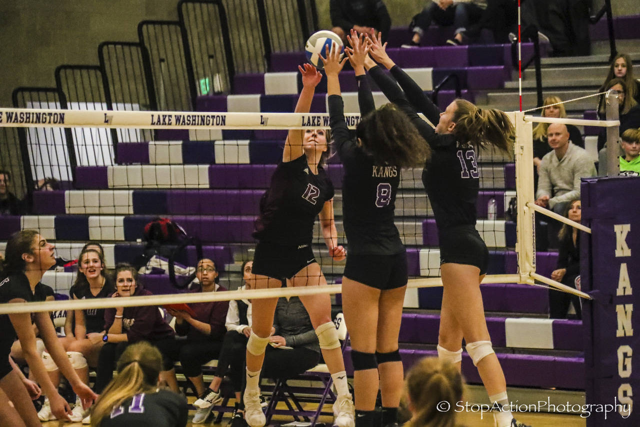 Mercer Island senior outside hitter Quinn Casey (12) hits the ball over the net during a 3A KingCo tournament game against Lake Washington on Nov. 7. Photo courtesy of Don Borin/Stop Action Photography