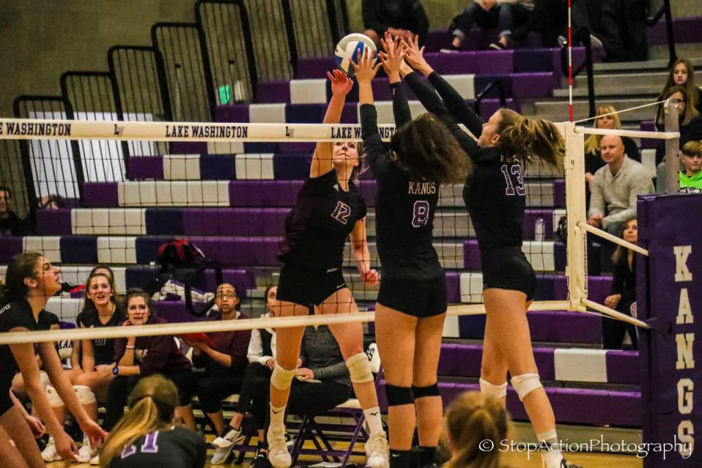 Mercer Island senior outside hitter Quinn Casey (12) hits the ball over the net during a 3A KingCo tournament game against Lake Washington on Nov. 7. Photo courtesy of Don Borin/Stop Action Photography