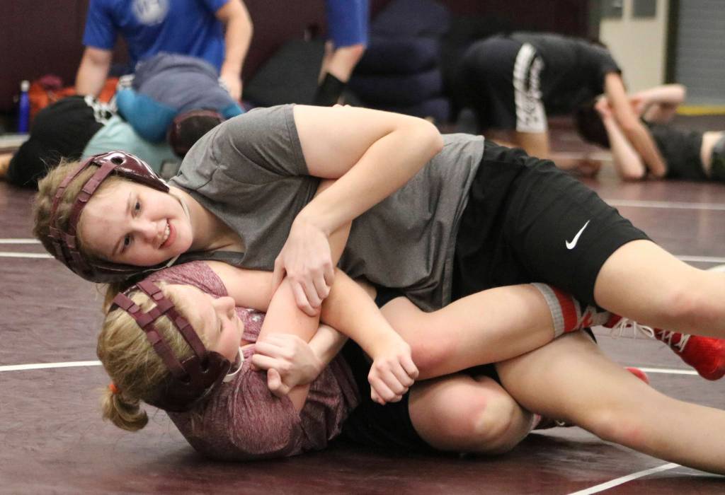Mercer Island wrestlers Brooke Wood and Nin Garr grapple during practice on Nov. 26. Benjamin Olson/staff photo