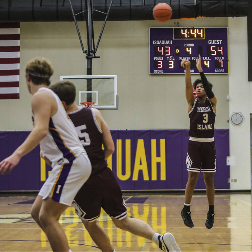 Mercer Island guard Chris Clark (right) shoots during the Islanders 62-54 victory over Issaquah on Dec. 4. Photo courtesy of Don Borin/Stop Action Photography