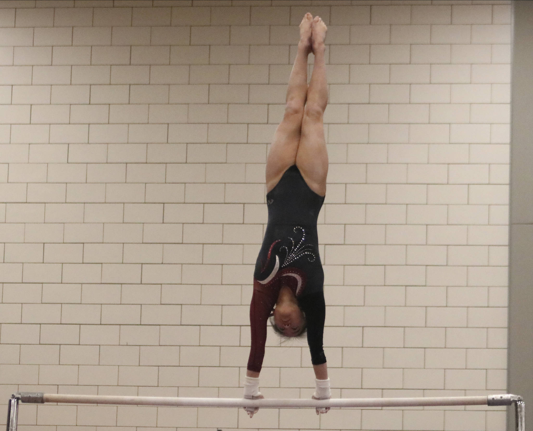 Mercer Island sophomore Rachel Ressmeyer performs giants on the bars. during a meet on Dec. 12, at Sammamish High School. Benjamin Olson/staff photo