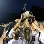 The Mercer Island Islanders girls lacrosse team hoists the state championship trophy following its 10-9 win against Bainbridge Island on May 17. Shaun Scott/staff photo