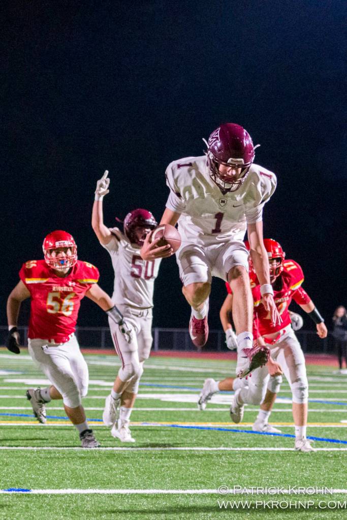 Mercer Island quarterback Liam Rogan leaps into the end zone in the second quarter of their 27-17 victory over the Newport Knights on Sept. 20. Photo courtesy of Patrick Krohn/Patrick Krohn Photography