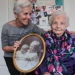 Natalie DeFord/staff photo                                Mercer Island resident Mary Ann Flynn and her mother, Aagot Kate Rosellini, who is turning 106 years old. They are holding a picture of Rosellini and her younger sister when they were small children.