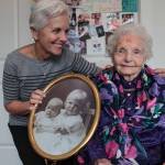 Natalie DeFord/staff photo                                Mercer Island resident Mary Ann Flynn and her mother, Aagot Kate Rosellini, who is turning 106 years old. They are holding a picture of Rosellini and her younger sister when they were small children.