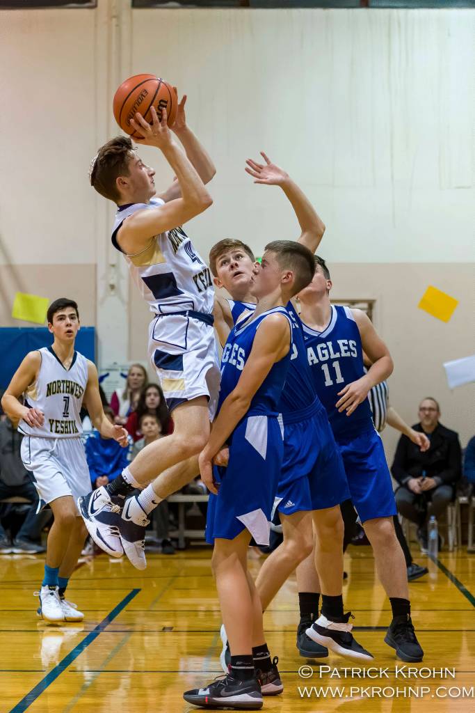 Northwest Yeshiva junior guard Dov Goldberg (shooting) takes a shot while teammate Victor Maimon (#1) looks on during the Lions 52-47 victory over Grace Academy on Dec. 14. Photo courtesy of Patrick Krohn/Patrick Krohn Photography