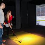 Bellevue residents Marko and Karla Ilicic play a hockey game in the Topgolf Swing Suite inside Forum Social House. Natalie DeFord/staff photo