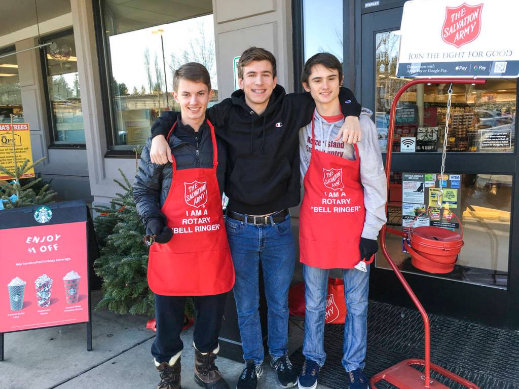 Mercer Island High School Interact Club members participated in bell ringing for Salvation Army with the Rotary Club of Mercer Island in late November and December 2019. From left: Charles Wischman, Peyton Rapo and Mathis Destouches. Courtesy photo.