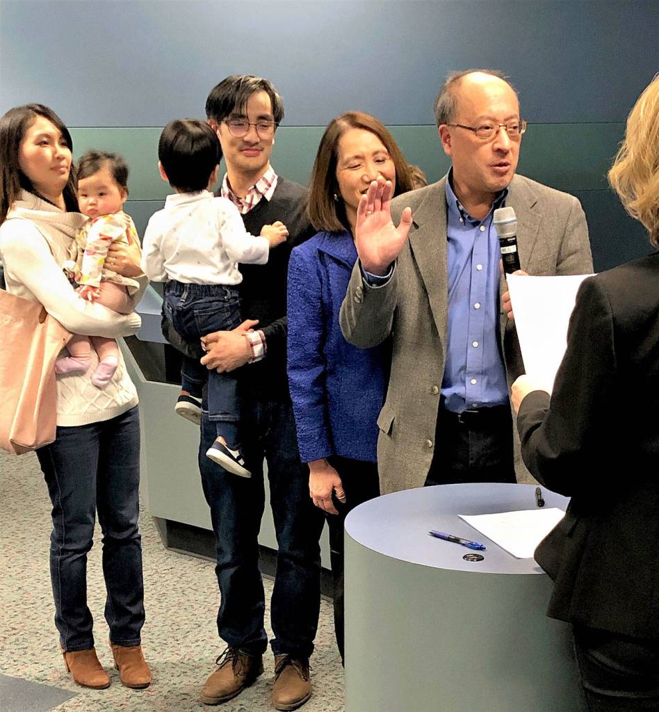 Surrounded by his family, Councilmember Benson Wong is sworn in as Mayor of Mercer Island by City Clerk Deb Estrada on Jan. 7, 2020. Photo courtesy of city communications manager Ross Freeman.