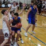 Luke Wenzel (left) attempts to draw a charge against the Liberty Patriots on Dec. 10. Wenzel has drawn 18 charges this season, eight away from the single-season record of 26 (Mike Ginn 1973-74). Photo courtesy of Don Borin/Stop Action Photography