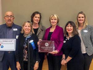 The Mercer Island Chamber of Commerce presents the 2019 Business of the Year Award to Covenant Living at the Shores (CLS). From left: CLSs Bob Bowen, Chamber of Commerce Board President Suzanne Skone, CLS Associate Executive Director Marykay Duran, CLSs Leslie McGee, CLS Sales Director Nancy Woo, and Chamber of Commerce Executive Director Laurie Givan. Courtesy photo.