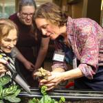 Courtesy photo                                Eldergrow program administrator Katy Dittmer works with Covenant Living at the Shores resident Althea Esterley at the communitys new indoor mobile sensory garden during at Jan. 17 kickoff event.