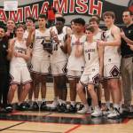 The Mercer Island boys basketball team celebrates its 61-36 victory over Interlake in the 3A KingCo championship game on Feb. 11 at Sammamish High School. Benjamin Olson/staff photo