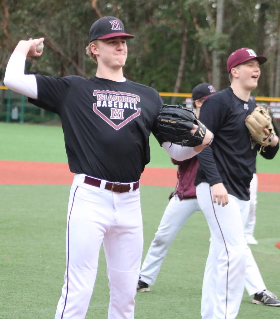 Mercer Island pitcher Duke Brotherton warms up his arm during a practice on March 5 at Island Crest Park. Benjamin Olson/staff photo