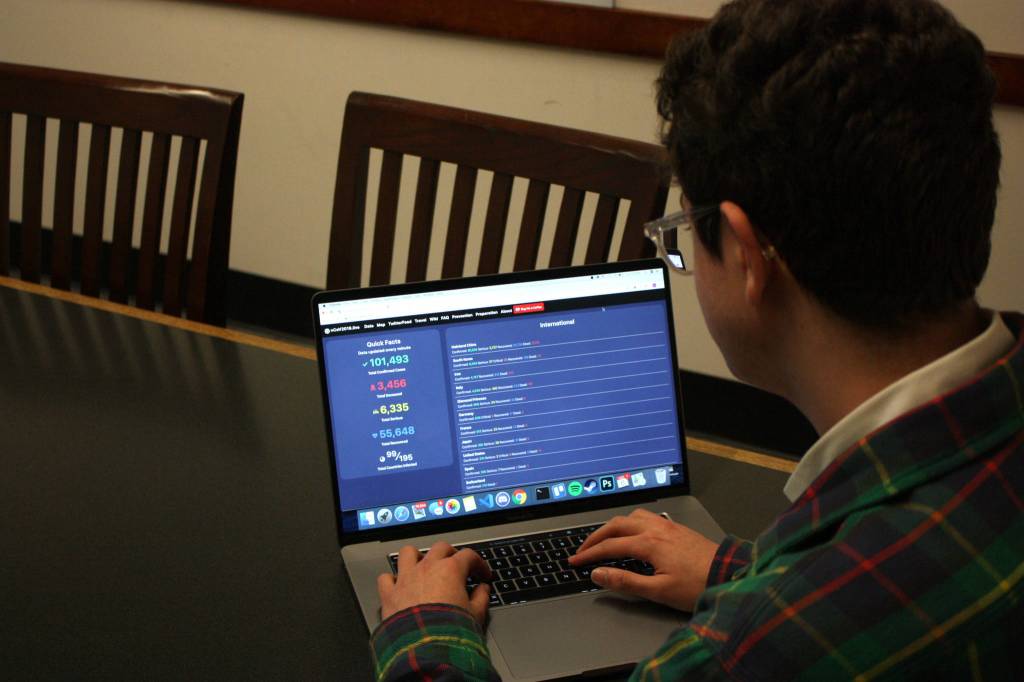Mitchell Atencio/Staff Photo                                Avi Schiffmann looks over his website in a conference room at the Mercer Island Library on March, 6, 2020. Schiffmanns website has received visits from every country on earth.