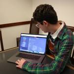 Avi Schiffmann looks over his website in a conference room at the Mercer Island Library on March, 6, 2020. Schiffmanns website has received visits from every country on earth. Mitchell Atencio/Staff Photo