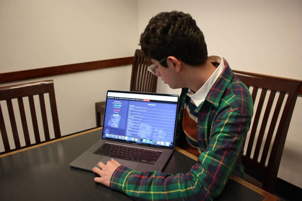 Avi Schiffmann looks over his website in a conference room at the Mercer Island Library on March, 6, 2020. Schiffmanns website has received visits from every country on earth. Mitchell Atencio/Staff Photo