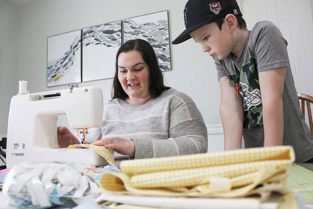 Angie Adam has been using materials given to her from her great grandmother to sew masks for health care workers. Ray Miller-Still/staff photo