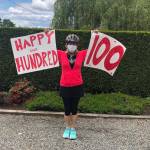 A neighbor holds signs wishing Jamerson a happy 100th. Photo courtesy Julie King Hately