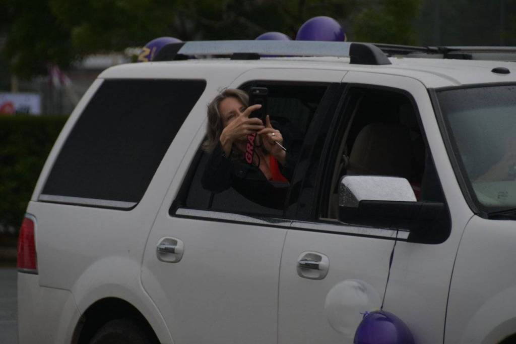 A parent taking pictures from their car. The event was designed so that students, families and school staff could properly adhere to social-distancing guidelines. Photo by Joe Chen