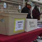 A booth was set up for students to pick up cords and community-service pins, as well as drop off books and uniforms. Photo by Joe Chen