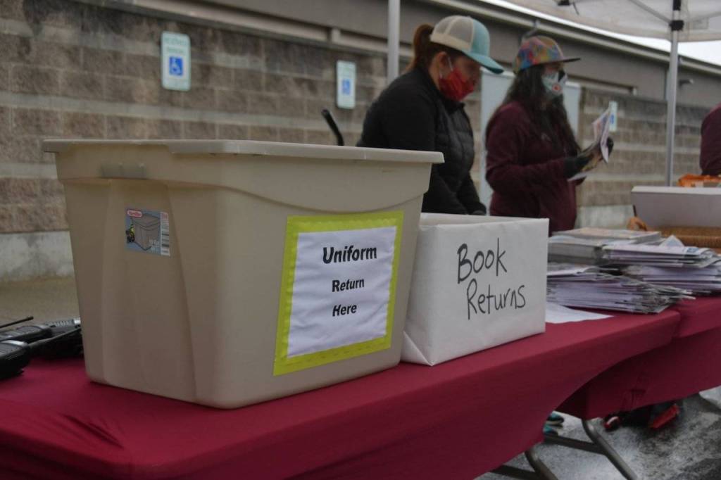 A booth was set up for students to pick up cords and community-service pins, as well as drop off books and uniforms. Photo by Joe Chen