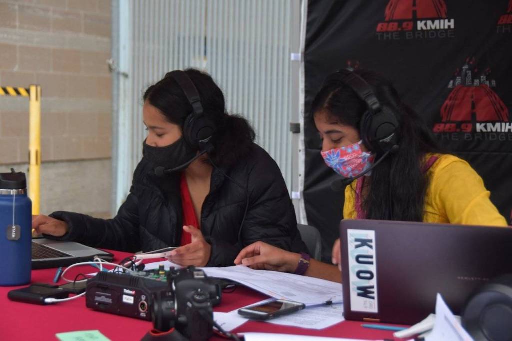 Students Meghana Kakubal and Lila Shroff, who are part of MIHSs student-run radio station The Bridge, provided narration during the event. Families could tune in from their cars. Photo by Joe Chen
